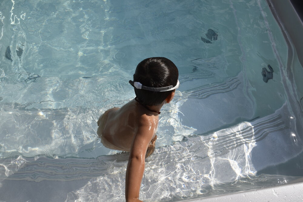 USSPA swim spa – fun for the whole family, child playing safely in an all-season pool.