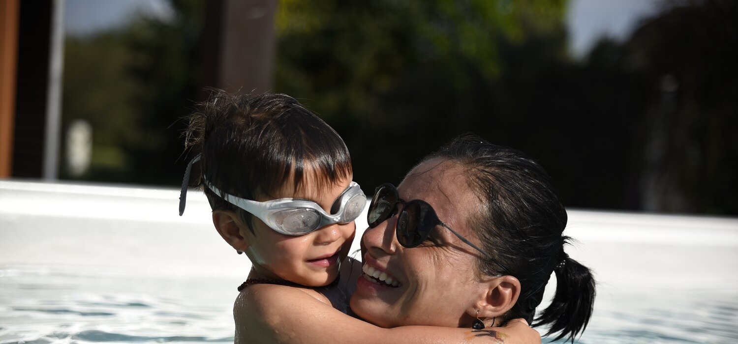 USSPA swim spa – family joy, child and mother swimming in an all-season pool.
