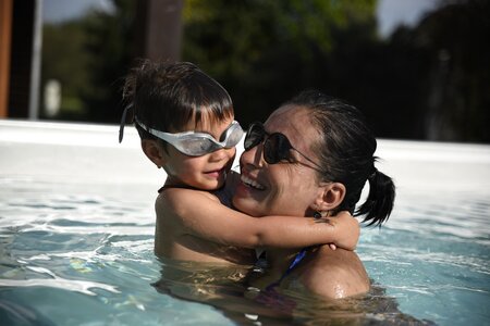 USSPA swim spa – family joy, child and mother swimming in an all-season pool.