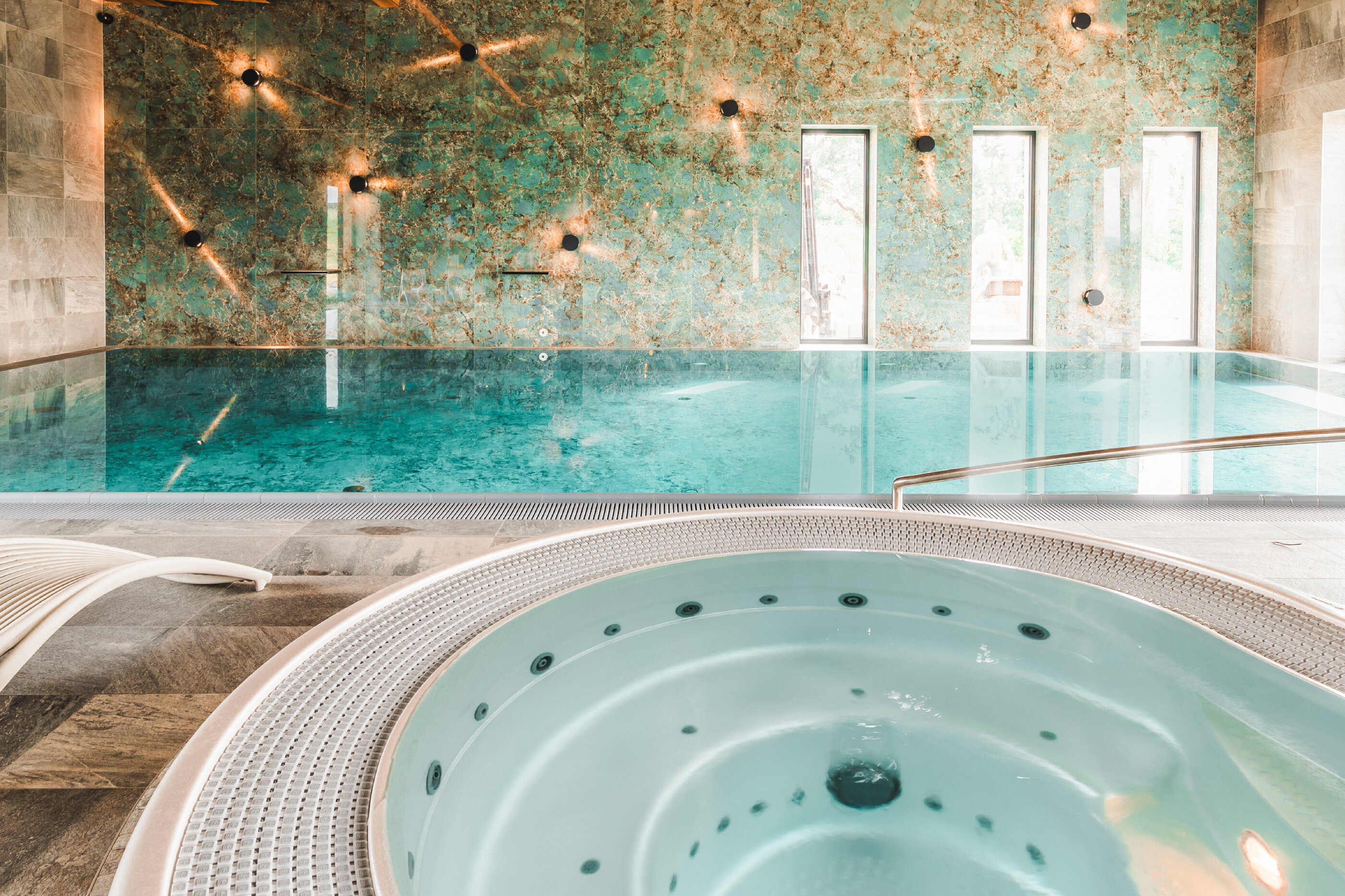 USSPA combination of a commercial Dino whirlpool with a swimming pool in hotel wellness area.