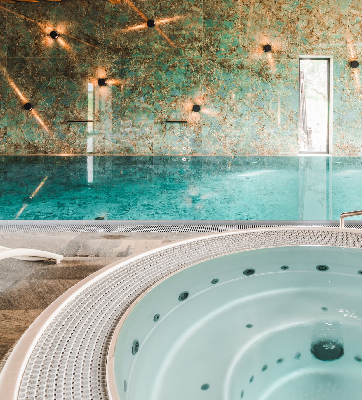 USSPA combination of a commercial Dino whirlpool with a swimming pool in hotel wellness area.