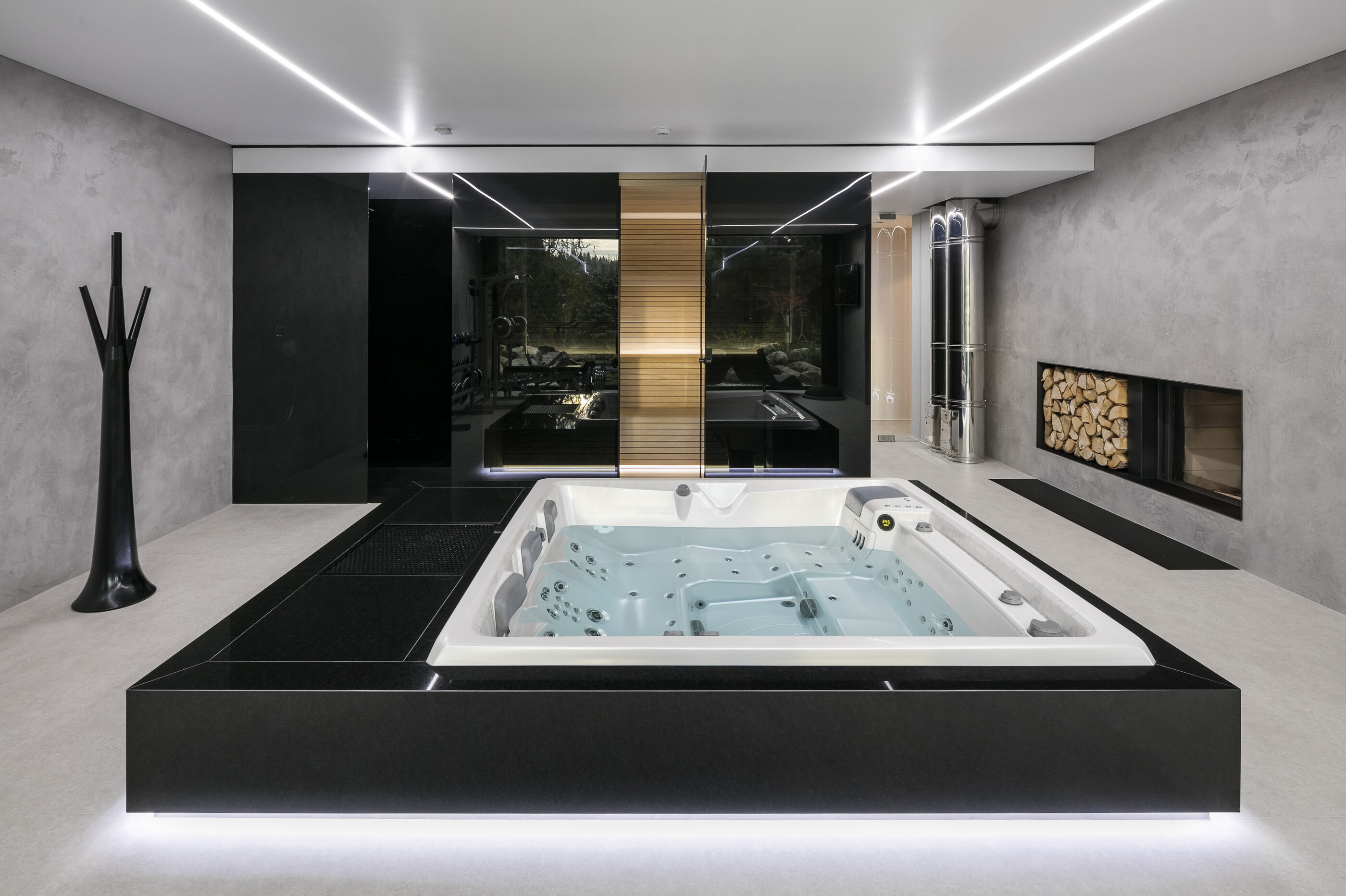 Indoor installation of the premium Persea iN hot tub from USSPA in a home wellness area.