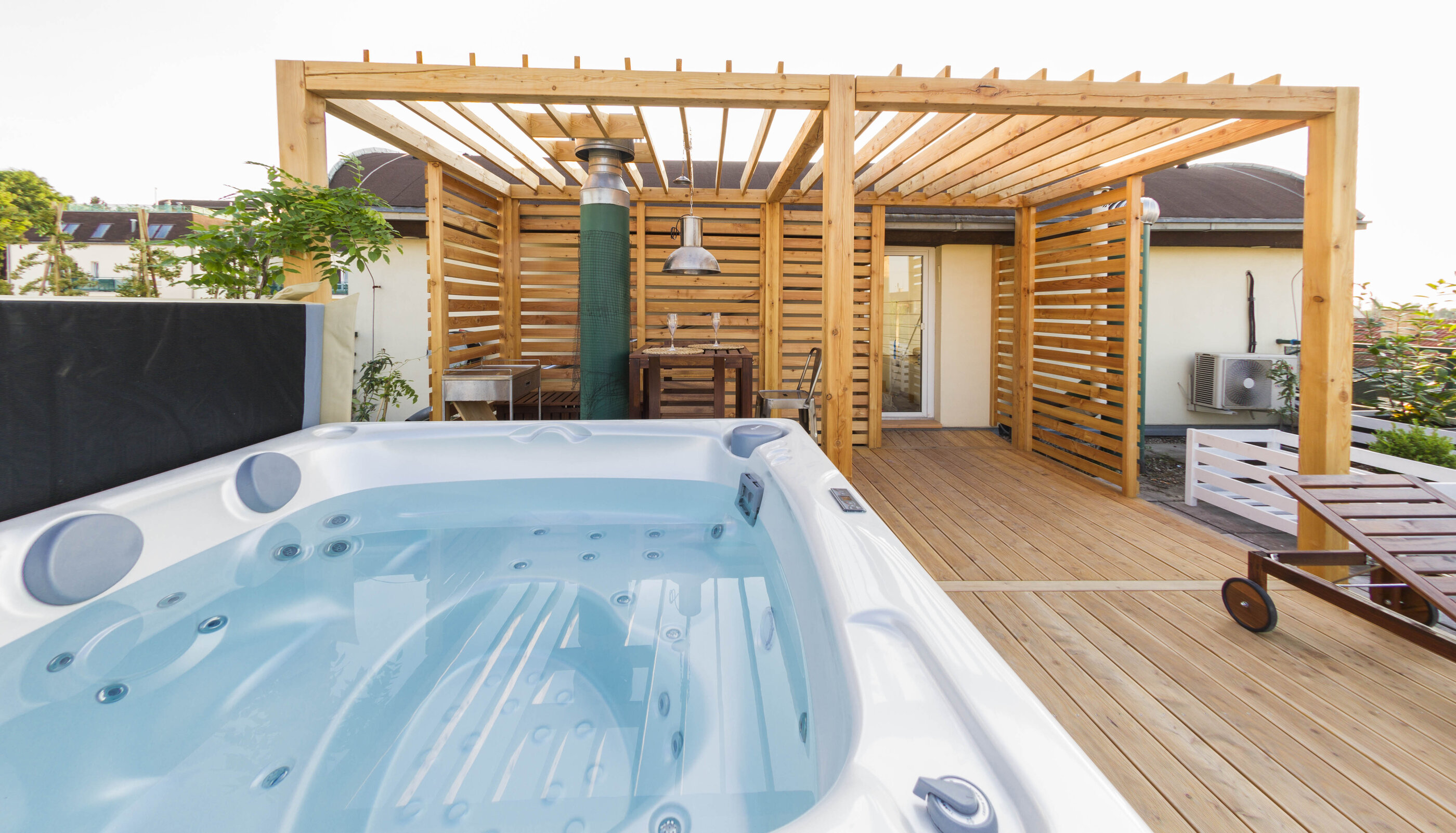 USSPA Aston hot tub installed on an outdoor terrace with a pergola in a modern elegant style.