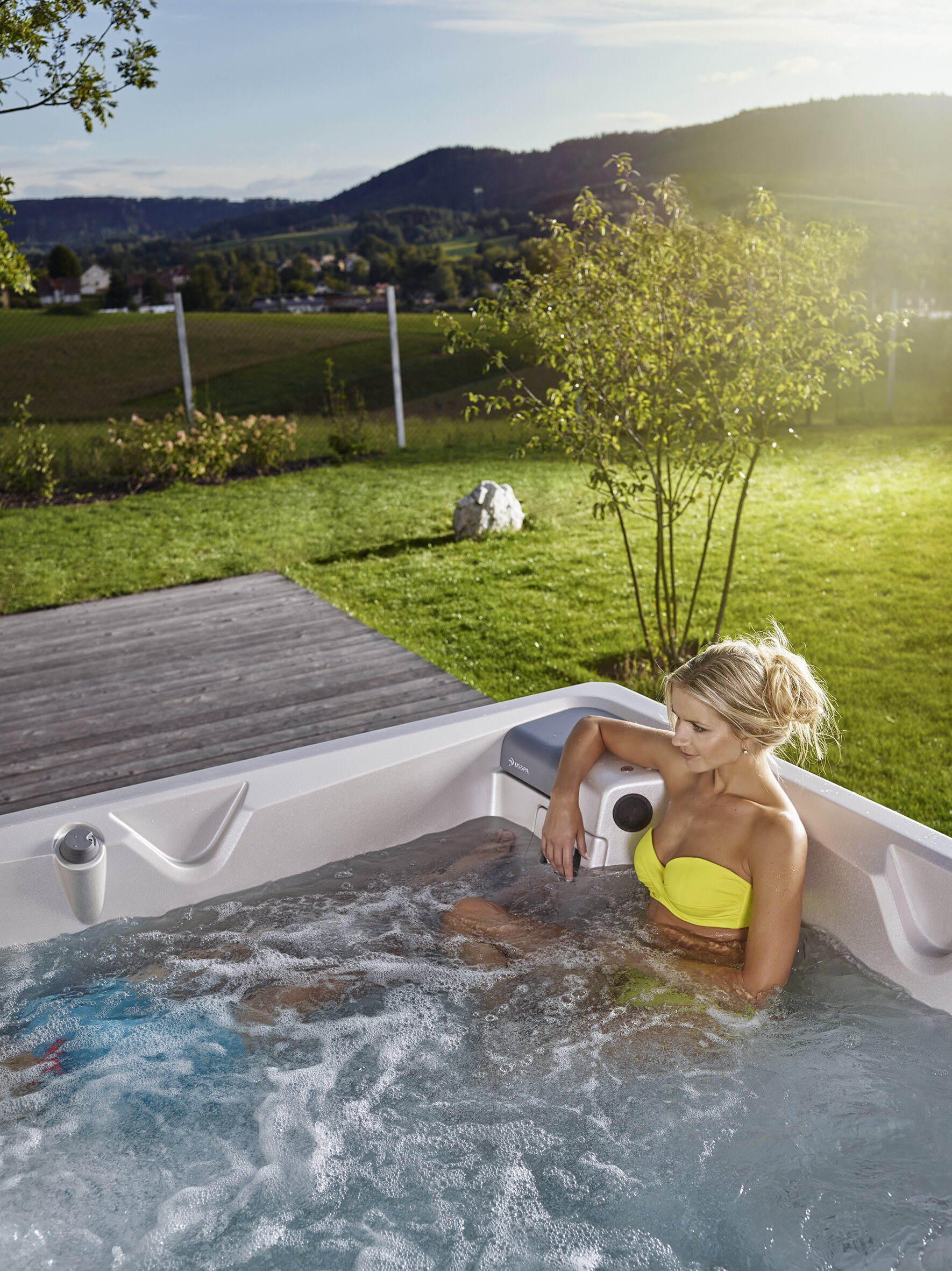 Woman in a USSPA whirlpool – relaxing in water, soothing body and mind at home or outdoors.