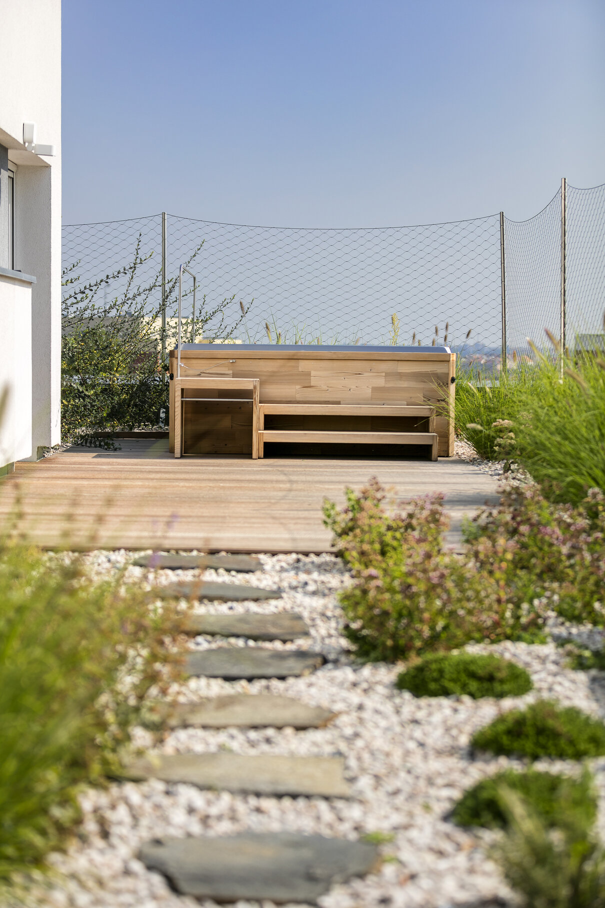 USSPA Persea iN outdoor whirlpool installed in the garden of a family home for ultimate relaxation.