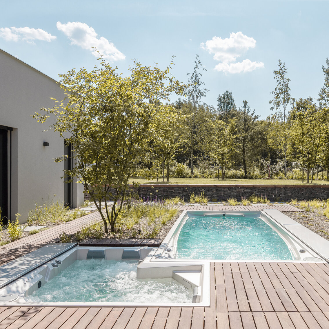USSPA whirlpool and swim spa from a Czech brand, installed in a family home garden.